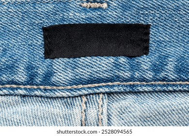 blank clothes label on blue jeans denim background - Powered by Shutterstock