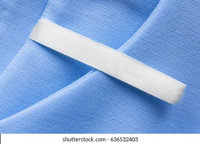 Blank Clothes Label On Blue Cotton As A Background