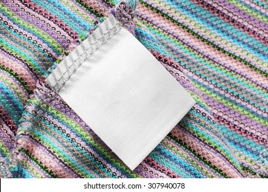 Blank Clothes Label On Knitted Cloth As A Background