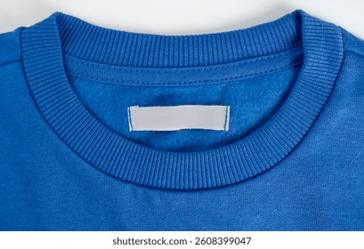Blank clothing label on a blue sweater