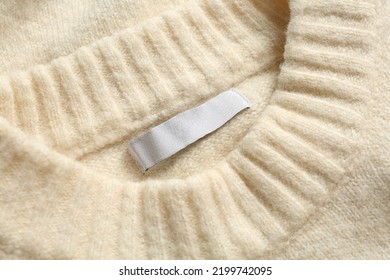 Blank Clothing Label On White Cashmere Sweater, Top View