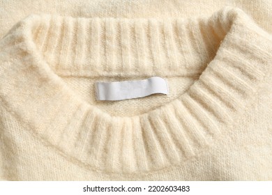 Blank Clothing Label On White Cashmere Sweater, Top View