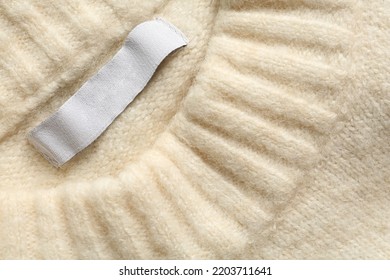 Blank Clothing Label On White Cashmere Sweater, Top View