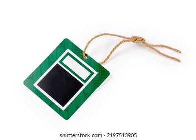 Blank Clothing Swing Tag In The Form Of Black And Green Carton Sheet On A Brown Rope On A White Background
