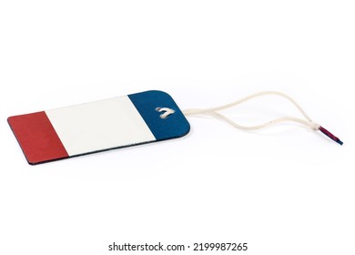 Blank Clothing Swing Tag In The Form Of Red White Blue Carton Sheet On A White Rope On A White Background
