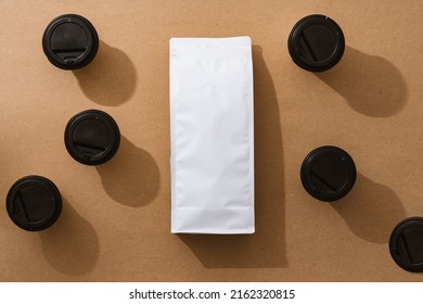 Blank Coffee Package With Copy Space And Takeout Cups On Beige Background, Top View