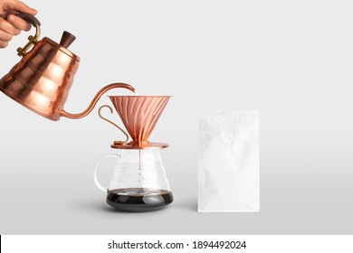 Blank coffee packaging container with a copper pot pouring coffee into dripper, front view, coffee packaging mockup with empty space to display your branding design.