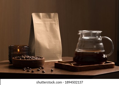 Blank coffee packaging on a wooden table, with pot, candle, coffee seeds bowl, on a wooden background, coffee packaging mockup with empty space to display your branding design.