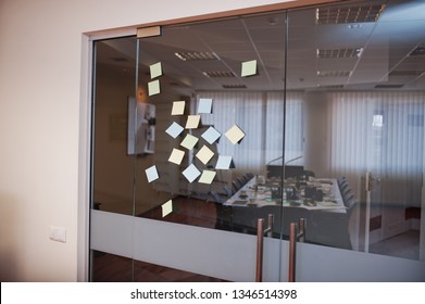 Blank Colored Sticky Note Or Post Note Stuck On Glass Wall At Office.