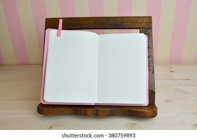 Blank Cook Book On Wooden Book Holder With Pink-yellow Kitchen Wall