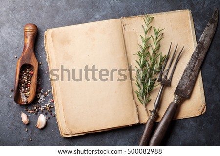 Blank cookbook for your text, herbs and spices. Top view over stone table with copy space