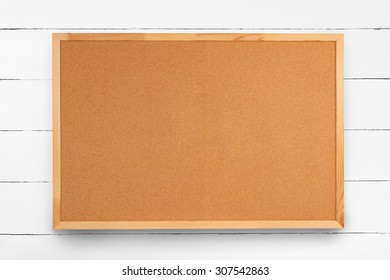 Blank Cork Board On White Wooden Wall 