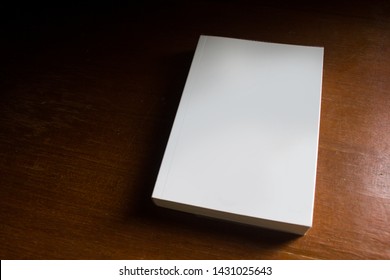 Blank Cover Empty Mockup Pocket Book In Morning Sunlight On Wooden Brown Textured Desk.