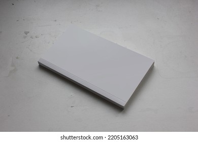 A Blank Cover Page Of A Vertical Closed Pocket Book Is Isolated On Minimal Dark Grey Background, For Catalog Presentation, Mystery Novel, Study Book, And Minimalism Literature Book Mockup. 