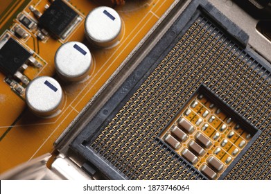 Blank cpu cpu socket with pins on motherboard in yellow color close-up