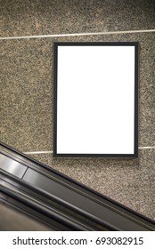 Blank Digital Poster Frame For Advertising On The Wall Inside Mall Building. Blank Digital Poster Frame Near Escalator. Vertical Image Of Poster Media.