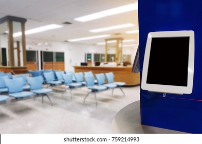 Blank Digital Touch Screen Monitor Or Tablet On Counter In Lobby For Waiting At Clinic Or Hospital, Medical Technology, Marketing, Advertisement Concept, Copy Space For Text Or Media Content