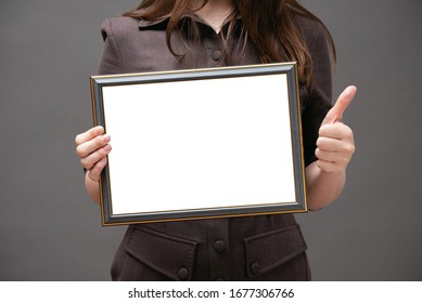 Blank diploma certificate mockup. Woman with empty photo frame with copy space close up.