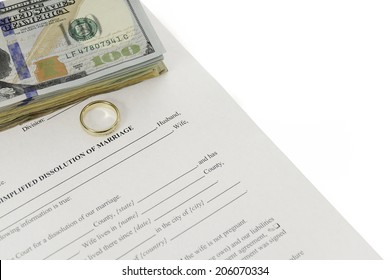 Blank divorce form with stack of hundred dollars bill and a single wedding ring. Form on diagonal, done on white background.