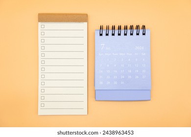 Blank to do list for text with checkbox and Simple desk calendar on JULY 2024. Empty Check list. Copy Space. isolated background. To do list in July 2024.