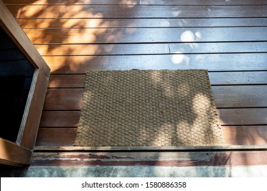 Blank Doormat On Wooden Floor Before The Door At Home. Mat On Wooden Floor, Product Mockup