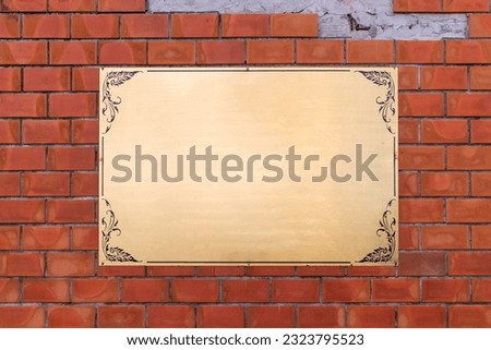 blank empty gold board on red brick wall background