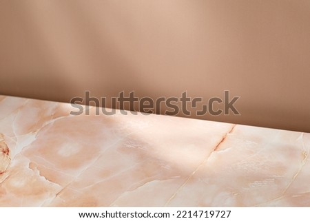 Blank, Empty scene, minimal pink beige marble background for product presentation. Beige wall with shadows. Design Template. Front diagonal view. Copy space.