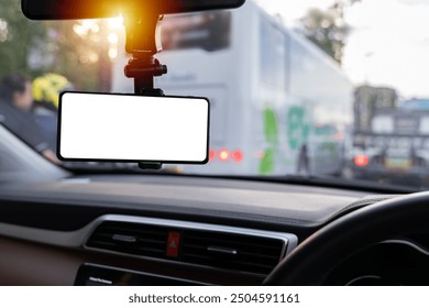 Blank empty screen. Copy space. Empty space for text. Mock up smart phone in car, clipping path. Smartphone in a car use for Navigate or GPS. Mobile phone with isolated white screen. 