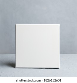 Blank Empty Square Canvas In Grey Room. Mockup Poster Frame.