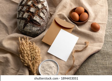 Blank Envelope And Card On A Fabric Background With Bread, Bakery Branding Mockup, Empty Space To Display Your Logo Or Design.