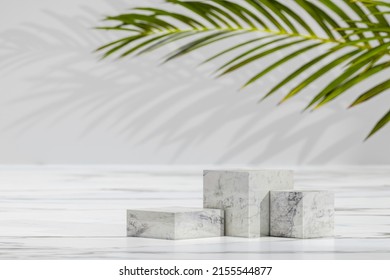 Blank Exhibition stage background or empty product shelf. Abstract minimal nature scene empty stage with three marble cube podiums on gray background and shadows of palm leaves - Shutterstock ID 2155544877