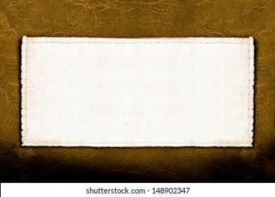 Blank Fabric Label On Leather Background Close Up