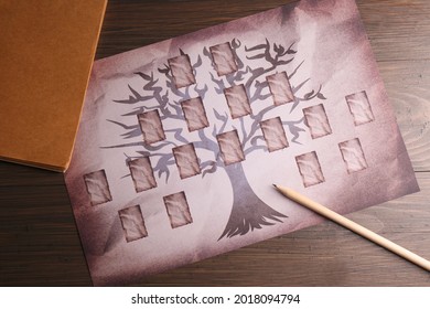 Blank family tree, notebook and pencil on wooden table, flat lay - Shutterstock ID 2018094794