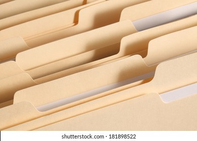 Blank File Folder Tabs In A Filing Cabinet Drawer. Primary Focus On Tabs Near The Front Of The Image. 