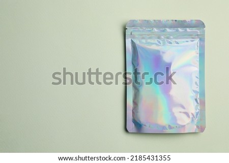 Blank foil package on light background, top view. Space for text