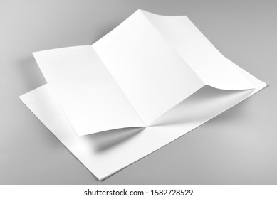 Blank Folded Flyer or Letterhead over Stack of Paper