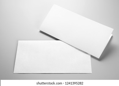 Blank folded letterhead and envelope over gray background