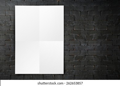 Blank Folded Paper Poster Hanging On Black Brick Wall,Template Mock Up For Adding Your Design.