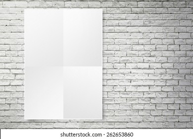 Blank Folded Paper Poster Hanging On White Brick Wall,Template Mock Up For Adding Your Design.