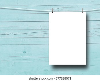 Blank frame with pegs on aqua wooden boards background