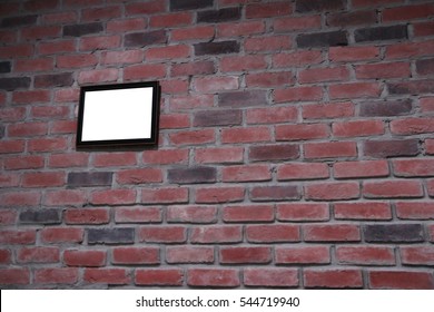 blank frames on brick wall