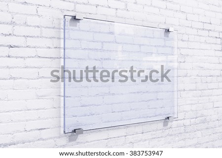 Blank glassy sighnboard on white brick wall, mock up