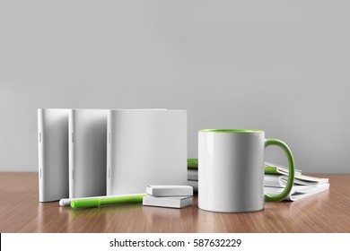 Blank goods on wooden table and grey background - Shutterstock ID 587632229