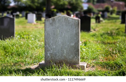 Blank gravestone with other graves and trees in background. Old stone. - Shutterstock ID 1117496669