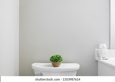 Blank gray bathroom wall above toilet, mock up