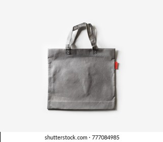 Blank Gray Fabric Canvas Bag For Shopping On White Paper Background. Flat Lay.