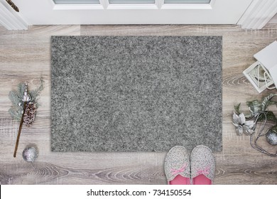 Blank Grey Doormat Before The Door In The Hall. Mat On Wooden Floor, With Christmas Decoration And Slippers. Welcome Home, Product Mockup