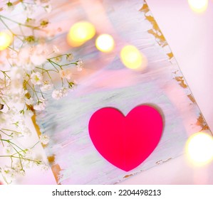 Blank Handmade Greeting Card, Red Heart, Invitation On Table. White Flower And Bokeh