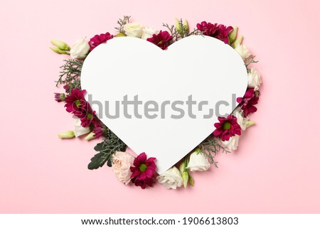 Blank heart and different flowers on pink background, space for text
