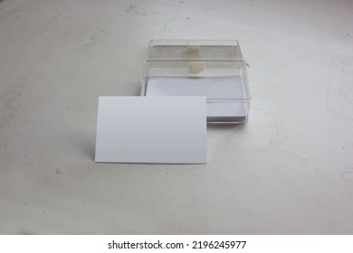 The Blank Horizontal Name Card For The Design Branding Identity Mockup, Stacked In The Old Grunge Transparent Glass Box, Is Isolated On A Dirty White Background. 